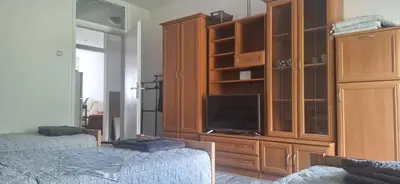a bedroom with two beds and a large wooden cabinet at Tamara in Drvar