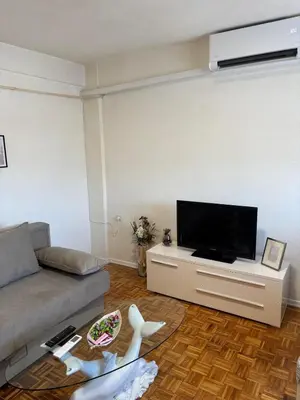 a living room with a couch and a flat screen tv at Apartment Banja Luka in Banja Luka