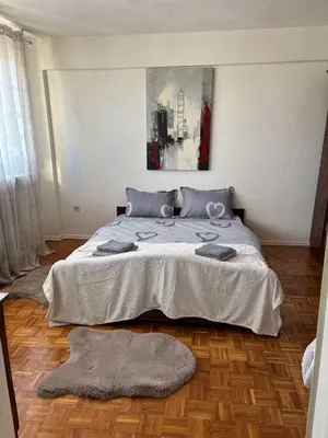 a bedroom with a large bed with two pillows on it at Apartment Banja Luka in Banja Luka