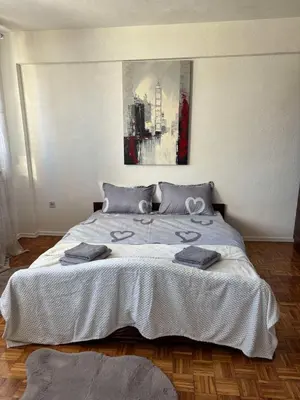 a bedroom with a large bed with two towels on it at Apartment Banja Luka in Banja Luka