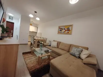 a living room with a couch and a table at Stan na dan Modriča in Modriča