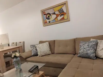 a living room with a brown couch and a table at Stan na dan Modriča in Modriča