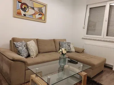 a living room with a couch and a glass table at Stan na dan Modriča in Modriča
