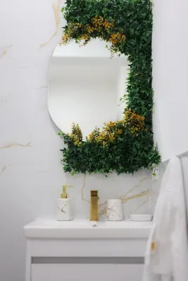a bathroom sink with a mirror and plants on it at Gold Luxury Apartment in Bosanska Gradiška