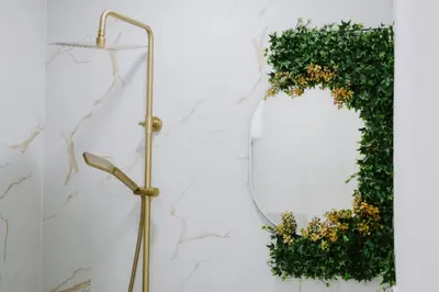 a mirror and a wreath on a wall at Gold Luxury Apartment in Bosanska Gradiška