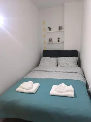 a bed with two white towels on top of it at Studio Apartment Borik 19 in Banja Luka