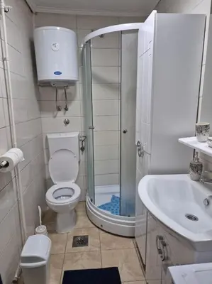 a bathroom with a shower and a toilet and a sink at Studio Apartment Borik 19 in Banja Luka