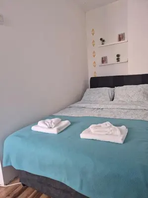 a bed with two towels on top of it at Studio Apartment Borik 19 in Banja Luka