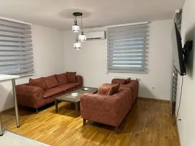 a living room with a couch and a table at Apartman Mia in Doboj