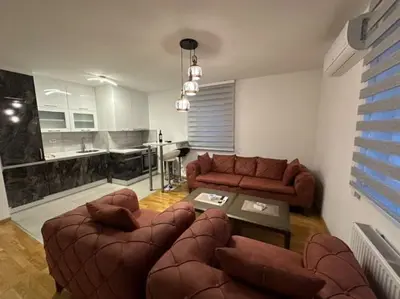 a living room with a couch and a table at Apartman Mia in Doboj