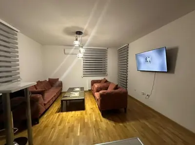 a living room with two couches and a tv at Apartman Mia in Doboj