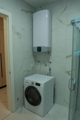 a washing machine in a bathroom with a wall at Apartment OMEGA in Banja Luka