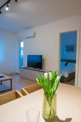 a living room with a vase of flowers on a table at Apartment OMEGA in Banja Luka
