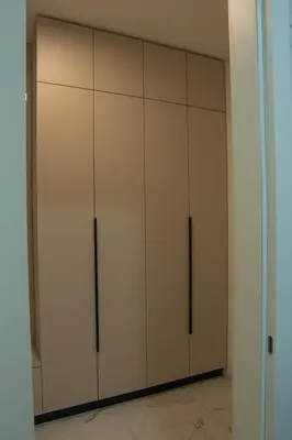 a closet with white cabinets in a room at Apartment OMEGA in Banja Luka