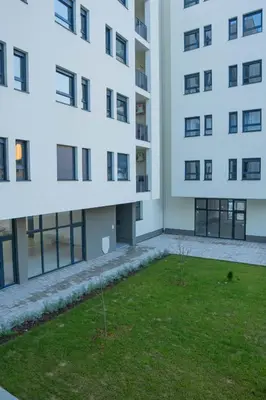 an apartment building with a lawn in front of it at Apartment OMEGA in Banja Luka
