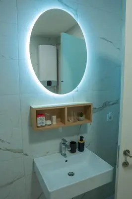 a bathroom with a sink and a mirror at Apartment OMEGA in Banja Luka