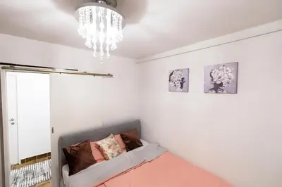 a room with a chandelier and a bed at Tanja in Banja Luka