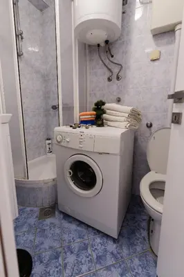a washing machine in a bathroom with a toilet at Tanja in Banja Luka