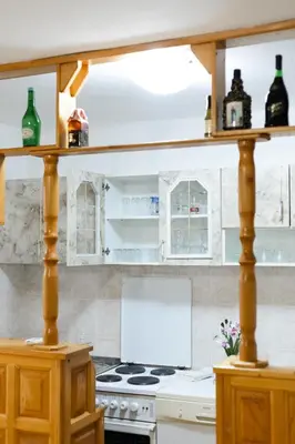 a kitchen with white cabinets and a stove top oven at Tanja in Banja Luka
