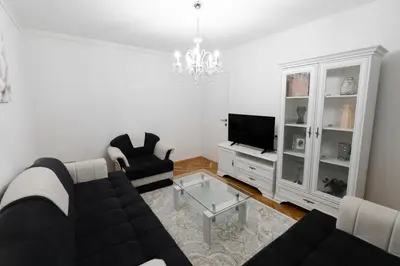 a living room with a couch and two chairs and a tv at Tanja in Banja Luka