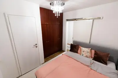 a bedroom with a bed and a chandelier at Tanja in Banja Luka
