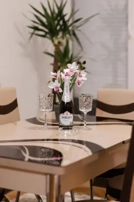 a bottle of champagne and two glasses on a table at Tanja in Banja Luka