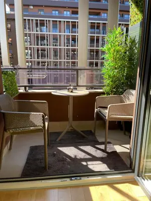 a balcony with a table and chairs and a large window at Lux Palata in Banja Luka