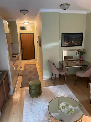a living room with a table and a dining room at Lux Palata in Banja Luka