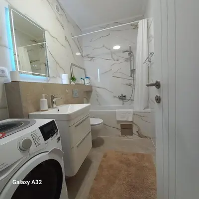 a bathroom with a sink and a toilet and a shower at Lux Palata in Banja Luka