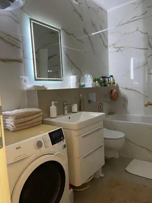 a bathroom with a washing machine and a sink at Lux Palata in Banja Luka
