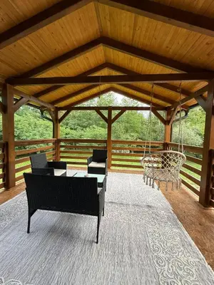 a pavilion with chairs and a swing at Vikendica Čardak in Srebrenik