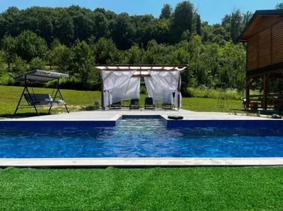 a pool with a gazebo in a yard at Vikendica Čardak in Srebrenik