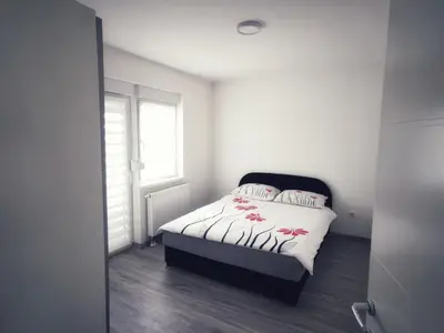 a bedroom with a bed and a window at Apartman Luxe in Livno