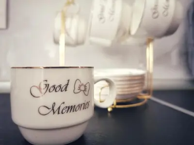 a coffee cup with the words good memories written on it at Apartman Luxe in Livno