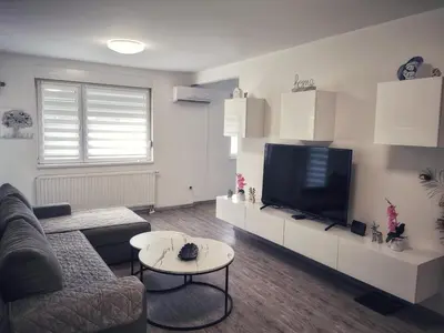 a living room with a couch and a flat screen tv at Apartman Luxe in Livno