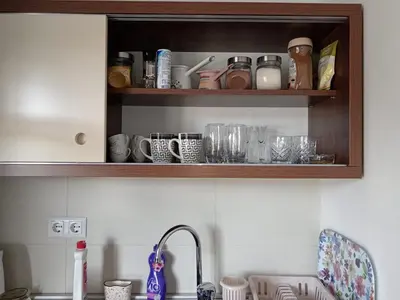 a kitchen counter with wooden cabinets with cups and dishes at Sweet Home Vlasic in Vlasic