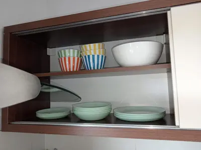 a shelf with bowls and plates on it at Sweet Home Vlasic in Vlasic