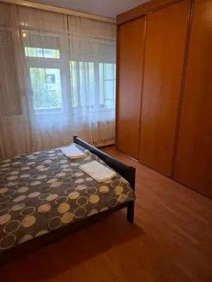 a bedroom with a bed and a cabinet and a window at Mia lux centar in Banja Luka