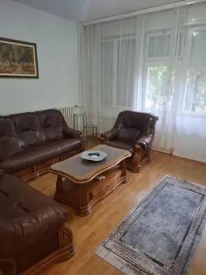a living room with leather couches and a coffee table at Mia lux centar in Banja Luka
