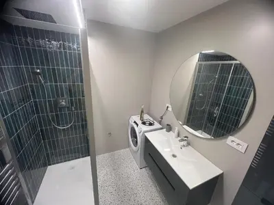a bathroom with a sink and a shower and a mirror at Aleja bb apartment in Banja Luka