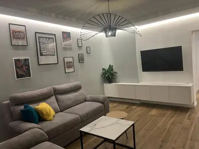 a living room with a couch and a flat screen tv at Aleja bb apartment in Banja Luka