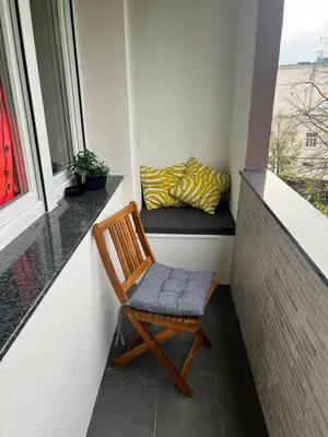 a chair sitting on a balcony with a window at Aleja bb apartment in Banja Luka