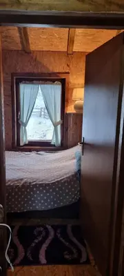 a small bedroom with a bed and a window at Planinska kuca Gogo in Kupres