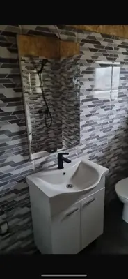 a bathroom with a white sink and a mirror at Planinska kuca Gogo in Kupres