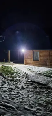 a building with a light on top of it at night at Planinska kuca Gogo in Kupres