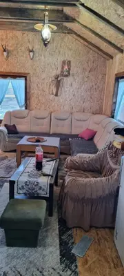 a living room with a couch and a table at Planinska kuca Gogo in Kupres