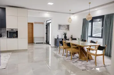 a kitchen and dining room with a table and chairs at Villa Bosanska Zvijezda in Vlasic