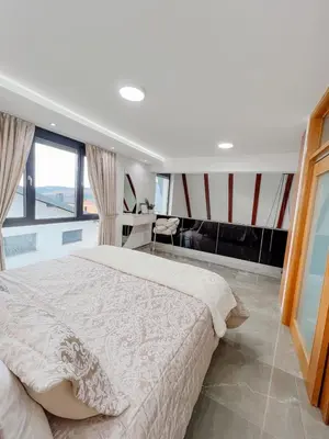 a bedroom with a large bed and a large window at Villa Bosanska Zvijezda in Vlasic