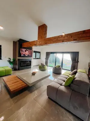 a living room with a couch and a table at Villa Bosanska Zvijezda in Vlasic
