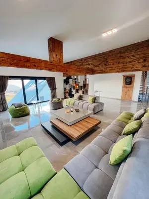 a living room with couches and a table at Villa Bosanska Zvijezda in Vlasic